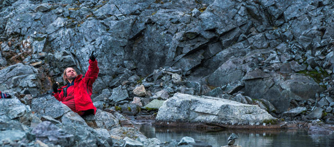 man in red jacket among the rocks
